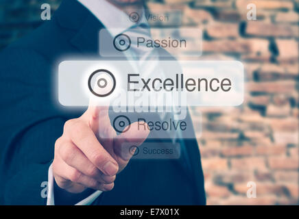 Businessman pressing a Excellence concept button. Instagram Styling Applied. Stock Photo