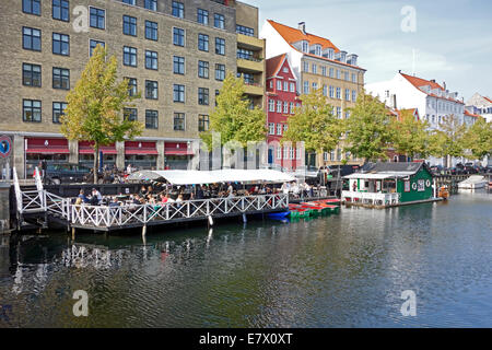Christianshavn Canal in Copenhagen Denmark with vessels along the quay and a a floating restaurant left. Stock Photo
