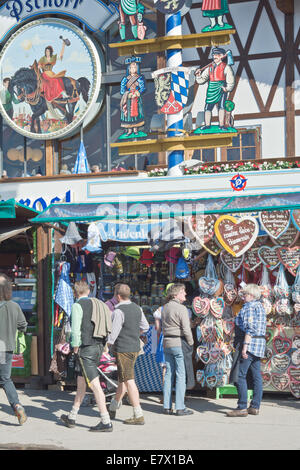 MUNICH, GERMANY – SEPT. 23, 2014: Crowds of visitors at the Oktoberfest visiting a Hut with Gingerbread Hearts. The Festival Stock Photo