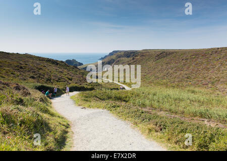 Coast path to Kynance Cove beach Cornwall the Lizard South West England uk with visitors and tourists enjoying summer sunshine Stock Photo