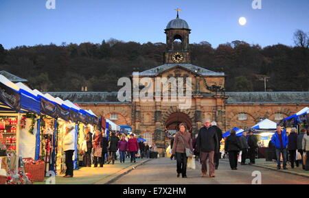 The Christmas Market in full swing outside the Stables in the grounds of  Chatsworth House, Peak District, Derbyshire England UK