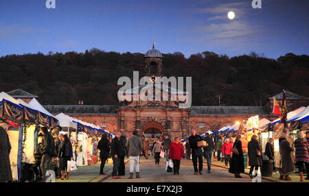 The Christmas Market in full swing outside the Stables in the grounds of  Chatsworth House, Peak District, Derbyshire England UK Stock Photo