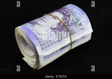 Roll of twenty pound notes held by rubber band Stock Photo