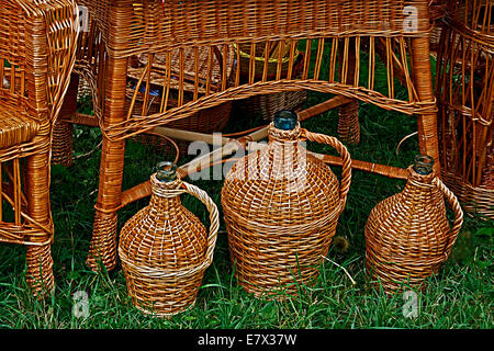 Decorative garden furniture and jugs, made from twigs and wicker. Stock Photo