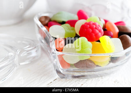 Colourful candies in heart shaped dish Stock Photo