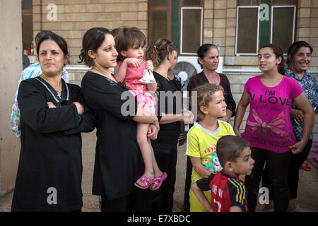 Erbil, Iraq. 25th Sep, 2014. Women and children of a group of Christian Kurdish refugees stand in front of St. Joseph's Church during the visit of German Minister of Defence Ursula von der Leyen in Ankawa near Erbil, Iraq, 25 September 2014. Von der Leyen made an unannounced trip to Iraq and assured Kurds in the North of the lasting solidarity for their fight against the Islamist terror militia Islamic State (IS). Photo: Maja Hitij/dpa/Alamy Live News Stock Photo