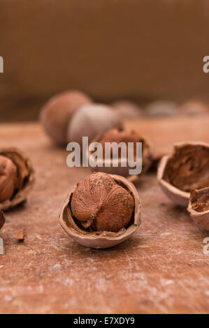 Organic cracked hazelnuts on a wooden board Stock Photo