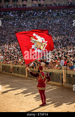 Man carrying a flag, historical parade before the Palio di Siena horse race, Siena, Tuscany, Italy Stock Photo