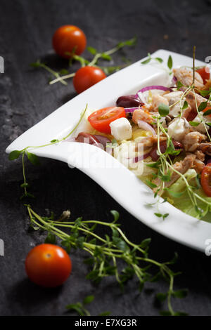 Fresh chicken salad with tomatoes and olives Stock Photo