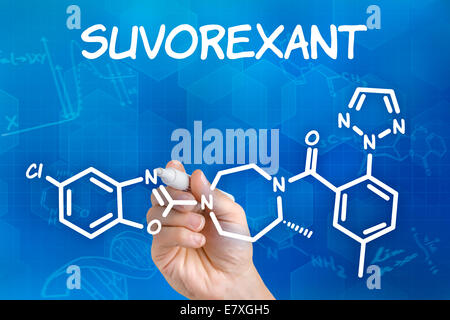 Hand with pen drawing the chemical formula of Suvorexant Stock Photo