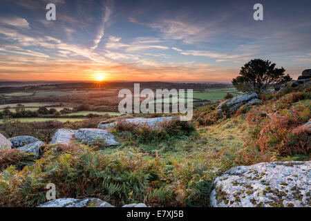 A beautiful Autumn sunrise from Helman Tor a rocky outcrop of rugged moorland and granite near Bodmin in Cornwall Stock Photo