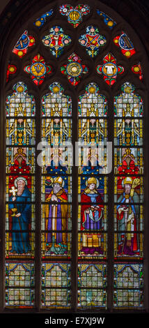 BRUGGE, BELGIUM - JUNE 13, 2014: The Windowpane with the saints in the in st. Giles (Sint Gilliskerk). Stock Photo