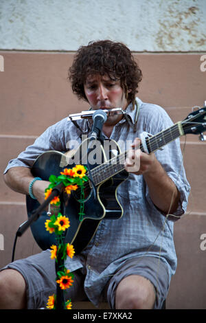 Perugia, Italy 19 July 2014: Street artist plays guitar in public square during the Umbria Jazz festival Stock Photo