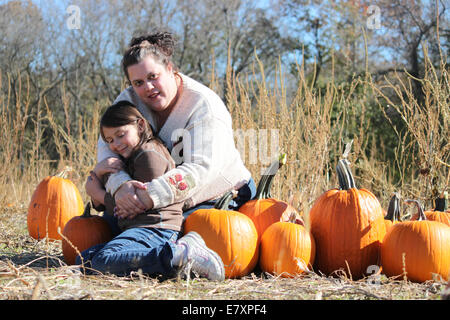 Fun Mother and Daughter portrait at the pumpkin patch Stock Photo