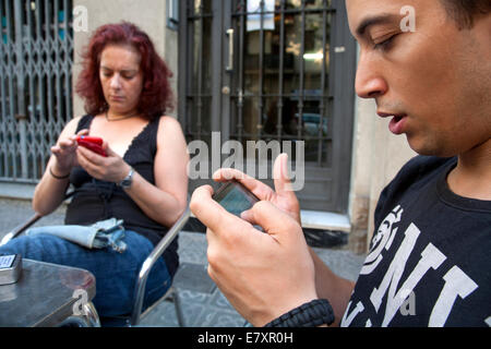 Man and woman using their mobile phones. Stock Photo