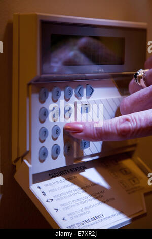 Woman setting home security system Stock Photo