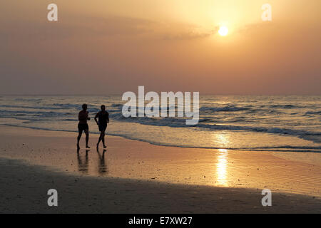 Two men jogging on the beach at sunset, silhouette, Al-Batinah province, Oman, Arabian Peninsula Stock Photo