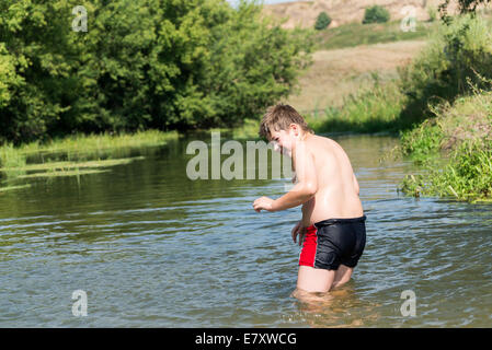 Full 10 years boy swim in river Stock Photo - Alamy