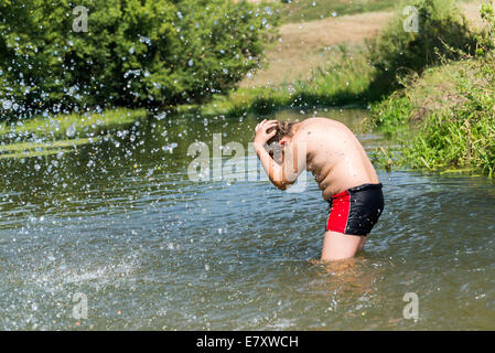 Full 10 years boy swim in river Stock Photo - Alamy