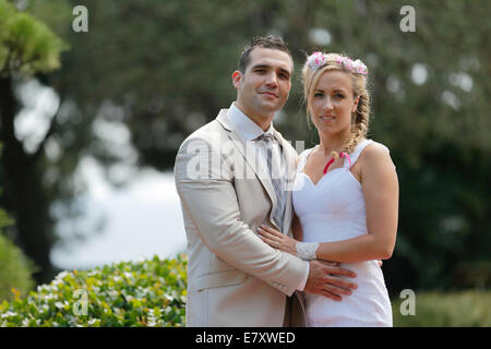 Bride and groom posing in a park Stock Photo