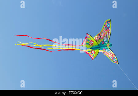 colorful kite flying in blue sky Stock Photo