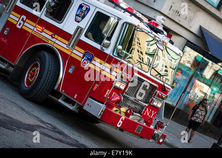 A New York Fire Department Engine answering an emergency call in Midtown New York. Stock Photo