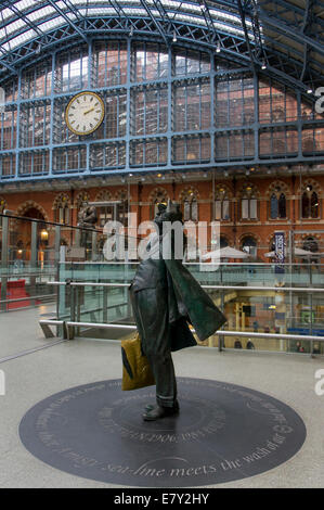 London St Pancras station - an interior view with clock & statue of John Betjeman looking up at high glass roof of historic train shed - England, UK. Stock Photo