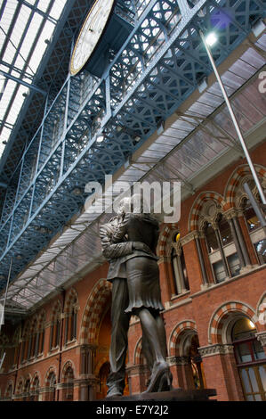 London St Pancras station - an interior view of historic Barlow train shed with close-up of Meeting Place sculpture under large clock - England, UK. Stock Photo