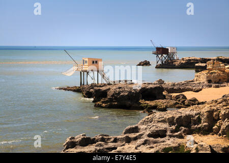 Traditional fisherman huts on stilts with carrelets nets on the coast of Charente Maritime France. Stock Photo