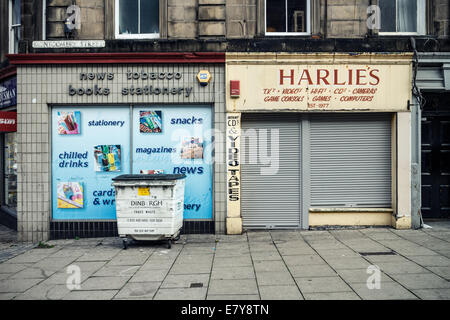 Old shuttered shop and bin. Street scene off Leith Walk, Edinburgh Scotland Stock Photo