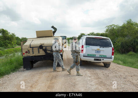 Hidalgo County, TX, USA. 26th September, 2014.  National Guard troops do a shift change on the Rio Grande levee near Anzalduas Park in Granjeno, TX south of Mission in Hidalgo County.  Texas Governor Rick Perry ordered troops on the border to supplement federal law enforcement. Credit:  Bob Daemmrich/Alamy Live News Stock Photo