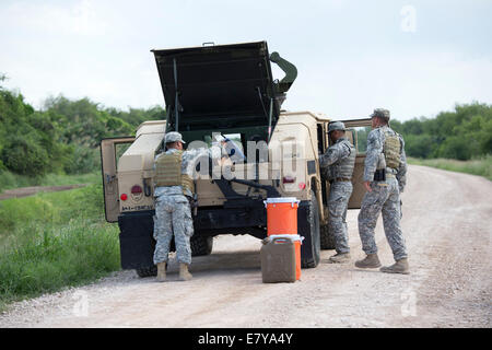 Granjeno, TX, USA. 26th September, 2014.  National Guard troops do a shift change on the Rio Grande levee near Anzalduas Park in Granjeno, TX south of Mission in Hidalgo County.  Texas Governor Rick Perry ordered troops on the border to supplement federal law enforcement. Credit:  Bob Daemmrich/Alamy Live News Stock Photo
