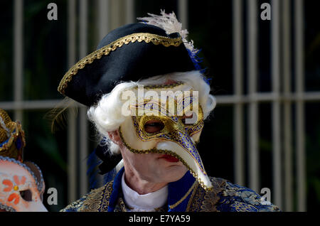 A performer in Venetian costume and mask poses in the inner courtyard of Andre Rieu's castle in Maastricht, The Netherlands, 25 September 2014. The Dutch violinist and his Johannes Strauss Orchestra played excerpts of his album 'Eine Nacht in Venedig' (lit. One night in Venice) in front of international members of the press for the first time. The album will be released on 31 October 2014. Afterwards a reception was held in the castle. Rieu will celebrate his 65th birthday on 01 October and start his tour through Germany in January 2015. Photo: HORST OSSINGER/dpa Stock Photo