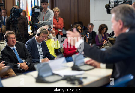 Berlin, Germany. 26th Sep, 2014. Deputy Chairman of the Board of Directors and Chairman of the Management Committee of Russian energy company Gazprom, Alexey Miller (L) listens to a press conference with European Commissioner for Energy Guenther Oettinger (R, CDU) on Russian gas supplies to Ukraine and the still outstanding payment in Berlin, Germany, 26 September 2014. Photo: Bernd von Jutrczenka/dpa/Alamy Live News Stock Photo