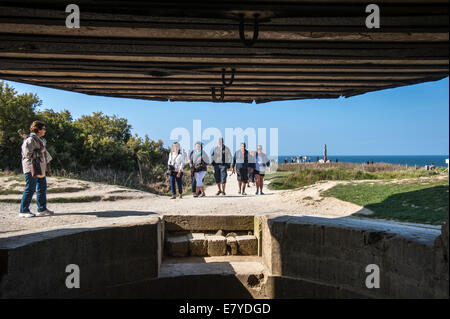 Tourists viewed from Second World War Two bunker at the Pointe du Hoc cliff overlooking the English Channel, Normandy, France Stock Photo