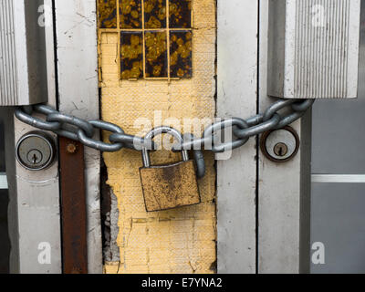 Lock and chain on a commercial buildings metal doors Stock Photo