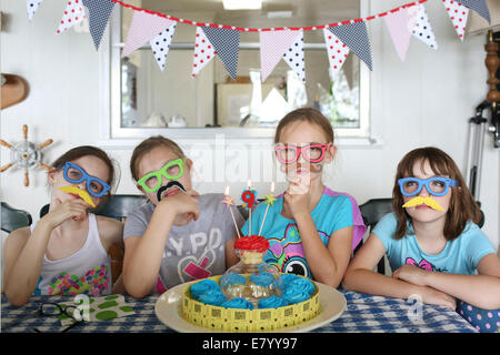 Girlfriends (6-7, 10-12) celebrating birthday Stock Photo