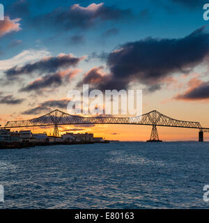 Astoria Oregon the Astoria-Megler Bridge across the Columbia River at sunset. The Astoria Megler Bridge connects Oregon with Washington State. Stock Photo