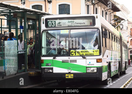 People getting into the trolley bus at the stop Plaza Grande on Guayaquil Street in the city center in Quito, Ecuador Stock Photo