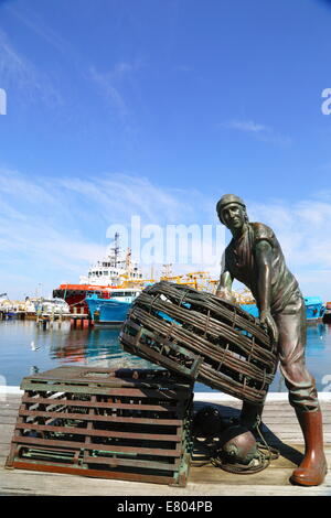 One of the two bronze sculptures of the Fishermen's Memorial in Fremantle's Fishing Boat Harbour, Western Australia. Stock Photo