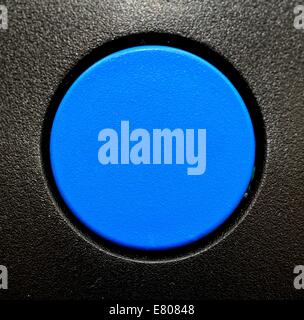 A blank blue button with a black plastic surround Stock Photo