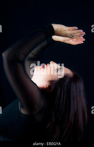 Portrait of a woman with with raised arms Stock Photo