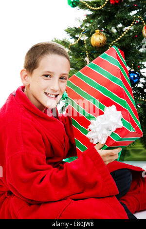 Little boy shaking a present on christmas morning. Stock Photo