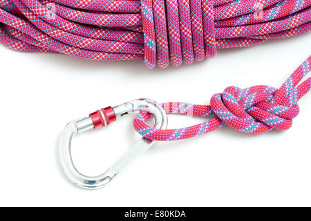 Carabiner attached to mountaineers rope, ready for climbing. Stock Photo