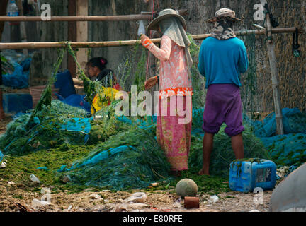 Fishermen's family is tending to nets,up keep,getting ready for next ketch Stock Photo