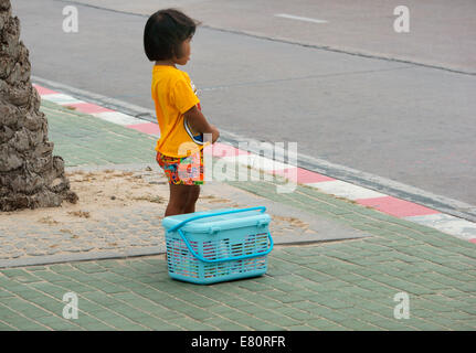 Young girl is waiting for the lift at he side of the road. Stock Photo