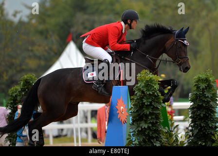 Incheon, South Korea. 28th Sep, 2014. Hayashi Tadahiro of Japan competes during the jumping team match of equestrian event at the 17th Asian Games in Incheon, South Korea, Sept. 28, 2014. Japan won the silver medal. Credit:  Zhu Zheng/Xinhua/Alamy Live News Stock Photo