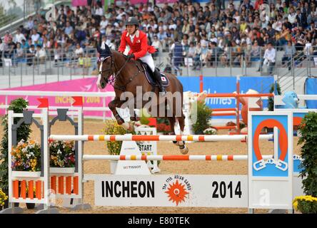 Incheon, South Korea. 28th Sep, 2014. Utsunomiya Takashi of Japan competes during the jumping team match of equestrian event at the 17th Asian Games in Incheon, South Korea, Sept. 28, 2014. Japan won the silver medal. Credit:  Zhu Zheng/Xinhua/Alamy Live News Stock Photo