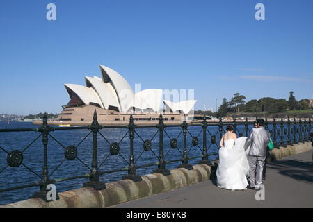 asian couple having wedding photos shot opposite the sydney opera house Stock Photo