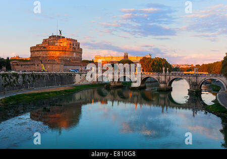 Castle Sant'Angelo and Ponte Sant'Angelo in Rome reflected in the Tiber River at sunset, a landmark site. Stock Photo